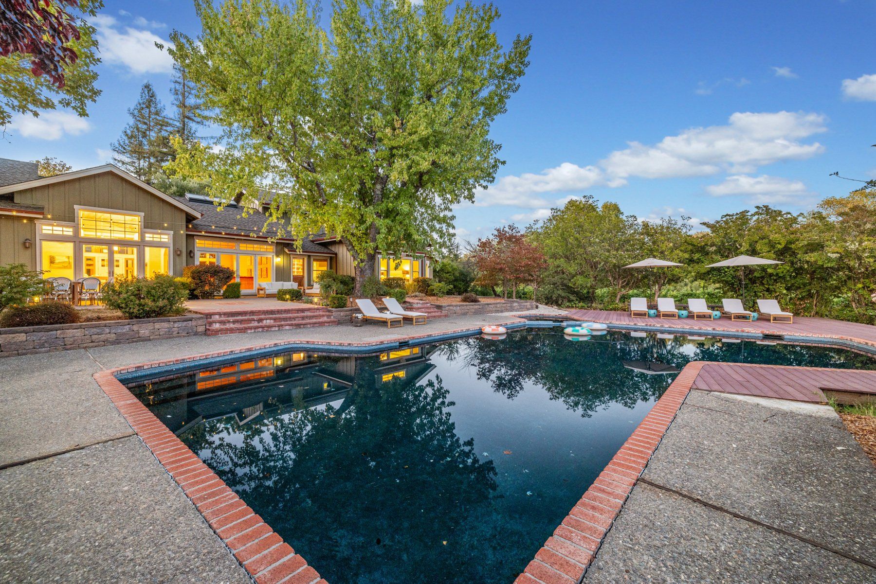Creekfront pool and house at dusk