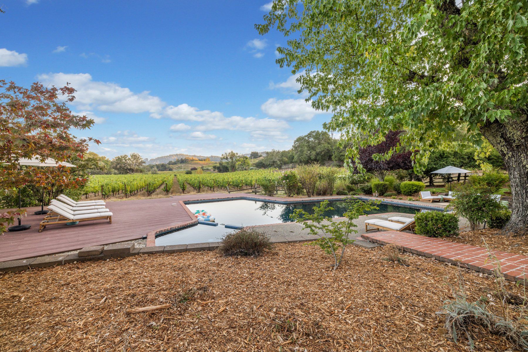Creekfront pool with main house