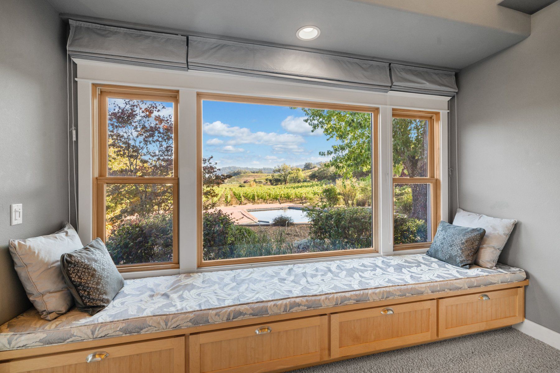 Creekfront primary bedroom with window seat