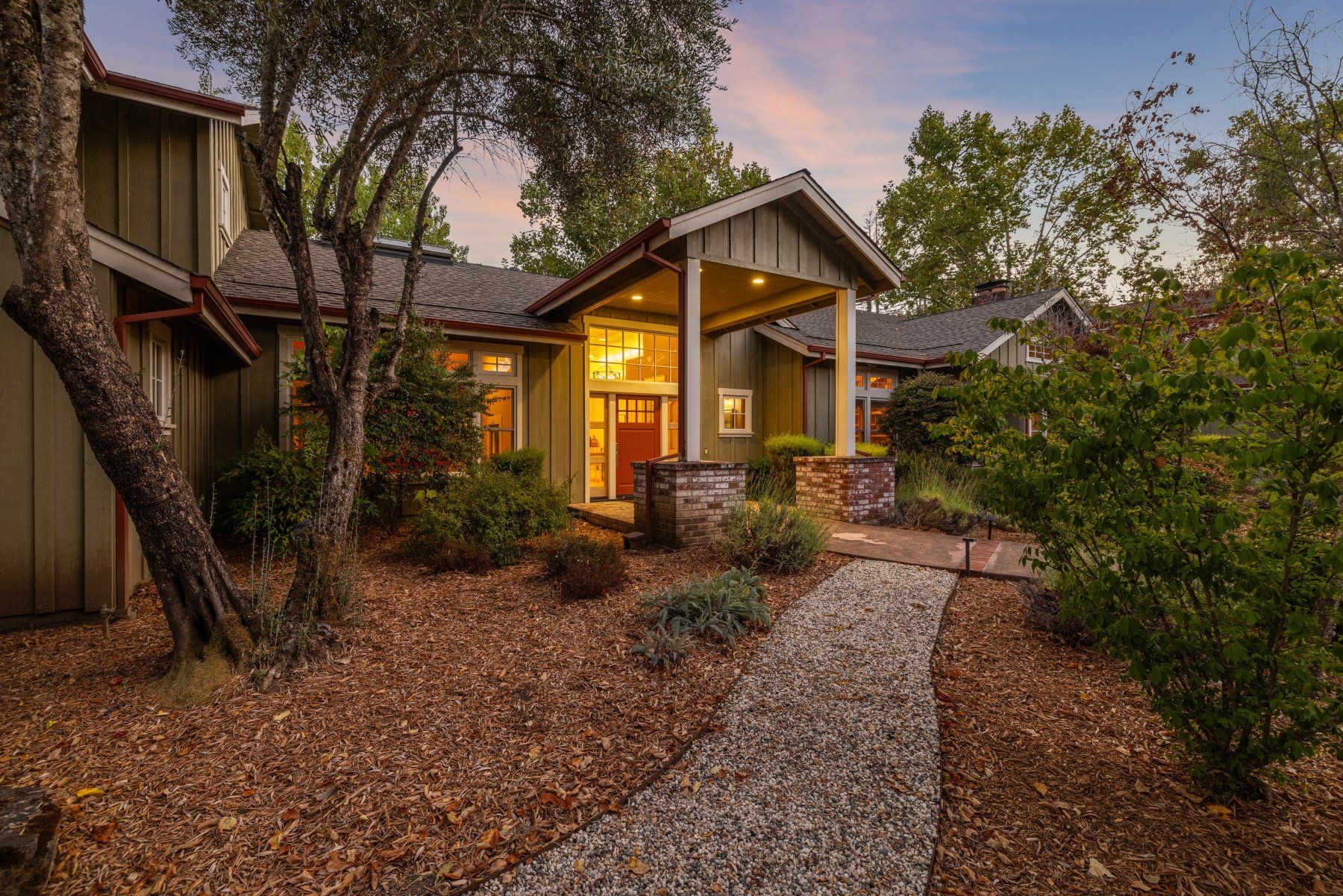Creekfront house lit at twilight